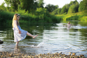Children walk in the summer in nature. Child on a sunny spring morning in the park. Traveling with children.