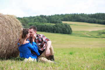 Naklejka premium couple in love in a field at sunset