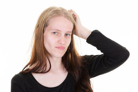 young puzzled woman blonde scratch head think wrong bad problem on white background girl facial expression emotion