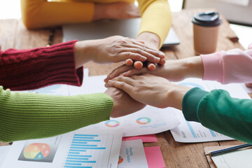 Teamwork with businessman analyzing cost graphs on table at conference room.