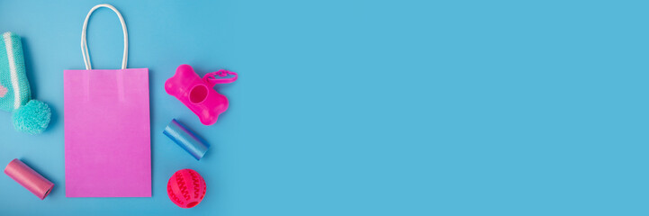 pet shop background, pet accessories, dog and cat goods and clothes with shopping bag on a blue...