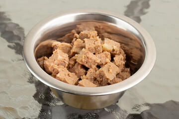 canned food for dogs and cats,pet food,wet feed in bowl on a table