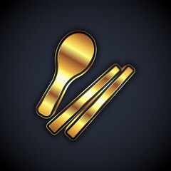 Obraz premium Gold Food chopsticks icon isolated on black background. Wooden Korean sticks for Asian dishes. Oriental utensils. Vector