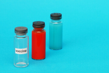 Three glass ampoules on a blue background.