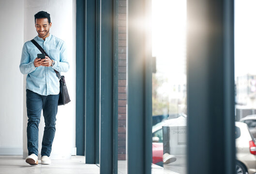 Professional man with phone, communication with typing or scroll through social media with smile. Happy young male, reading text and contact with network, technology and creative employee at startup