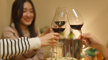 Birthday celebration concept, Asian girls clinking glass wine in dinner to celebrate birthday party