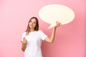 Young Lithuanian woman isolated on pink background holding an empty speech bubble and doing coming...