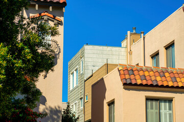 Downtown buildings with beige and cream exterior color with front yard trees in urban area of american city
