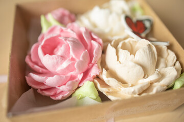 sweet dessert, marshmallow in the shape of a pink peony flower on a light background. Sugar addiction, consumption, handmade dessert. Low calorie marshmallows, carbs