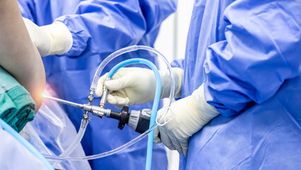 Team of doctor did arthroscopic orthopedic shoulder surgery inside operating room in hospital in...
