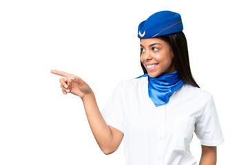 Airplane stewardess African american woman over isolated background pointing finger to the side and presenting a product