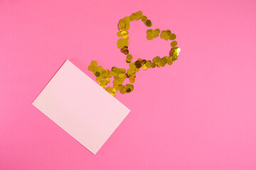 Pink paper envelope mockup on pink background. Flat lay, top view. Romantic love letter for Valentine's day concept.