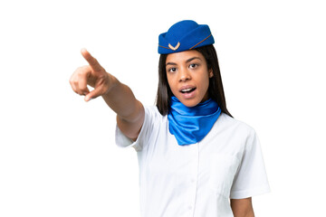 Airplane stewardess African american woman over isolated background pointing away