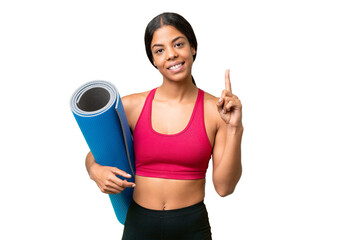 Young sport African American woman going to yoga classes while holding a mat over isolated background showing and lifting a finger in sign of the best