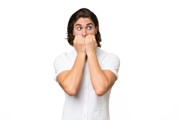 Young caucasian man isolated on green chroma background nervous and scared putting hands to mouth