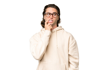 Young caucasian man isolated on green chroma background nervous and scared