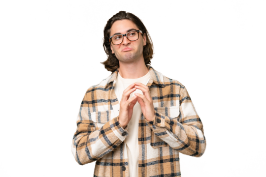 Young caucasian man isolated on green chroma background scheming something