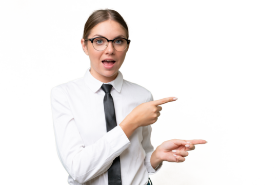 Young business caucasian woman over isolated background surprised and pointing side