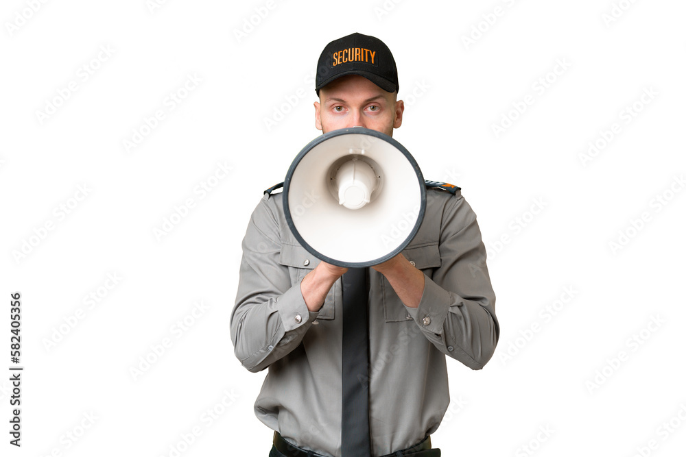 Wall mural Young security caucasian man over isolated background shouting through a megaphone