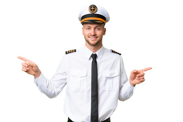 Airplane pilot man over isolated background pointing finger to the laterals and happy © luismolinero