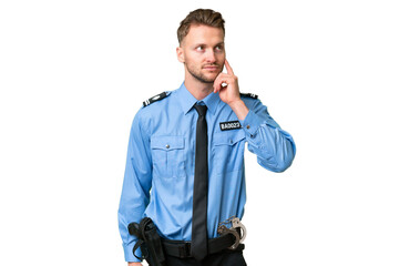Fototapeta premium Young police man over isolated background thinking an idea while looking up