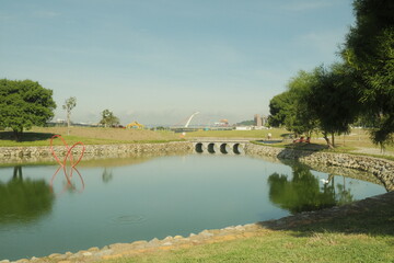 Tranquil Riverside Scene with Bridge and Trees