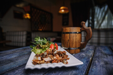 appetizer of small fried ribs on a white plate
