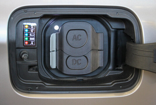 Covered charging ports of a new electric vehicle