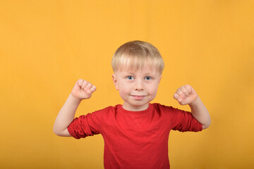 cute boy child showing muscles