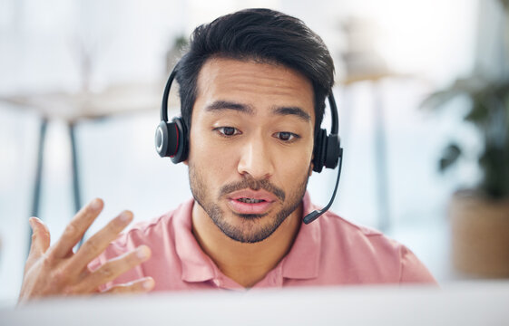 Asian Man, Call Center And Consulting With Headphones On Computer For Customer Service, Help Or Support At Office. Male Consultant Agent Talking With Headset On PC For Telemarketing Or Online Advice