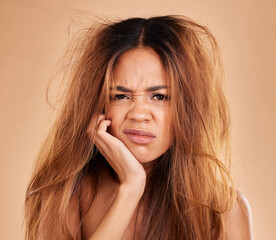 Face portrait, hair loss and sad woman in studio isolated on a brown background. Salon, keratin...