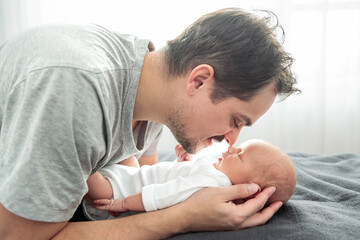 Obraz premium A Portrait of a father, with her nursing baby on bedroom