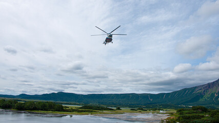 Fototapeta na wymiar Helicopter flying in the Uzon Caldera. Kronotsky Nature Reserve on Kamchatka.