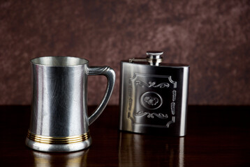 Old Pewter Tankard and Steel Hip Flask on a Wooden Shelf