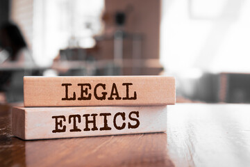 Wooden blocks with words 'LEGAL ETHICS'. Business concept