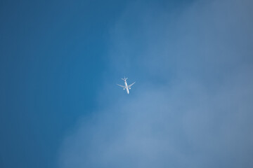 passenger airliner in the blue sky sunny day - flight above the clouds