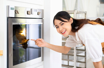 Fototapeta na wymiar Woman Baking In Oven . young pretty woman warming prepare oven to cook or baking. domestic kitchen concept