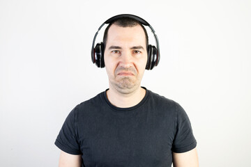 young man male guy model wearing headphones cool fashion style looks unhappy angry stand wear bad...