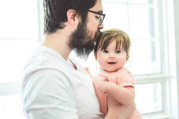 Fototapeta premium A Portrait of a beautiful father, with her nursing baby