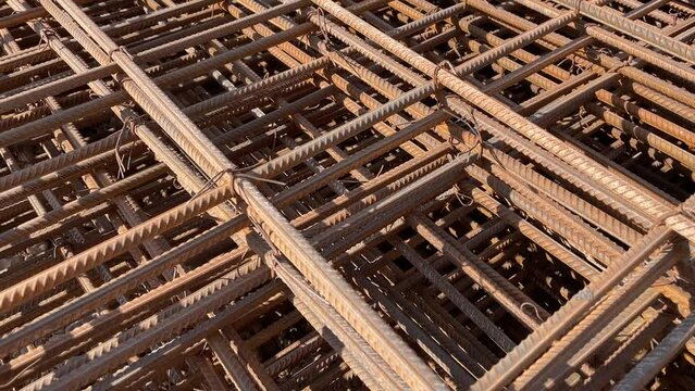 Steel wire mesh piles. Industrial background. Rebar texture. Rusty rebar for concrete pouring. Steel reinforcement bars. Closeup of Steel rebars.