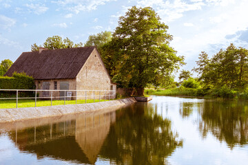 Fototapeta premium Old house on the bank of the canal. Rural landscape in Holland 