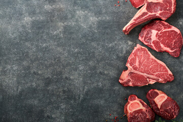 Raw prime steaks. Variety of fresh black angus prime meat steaks T-bone, New York, Ribeye,...