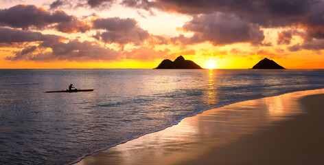 sunset in hawaii with kayak in water