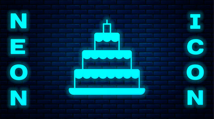 Glowing neon Wedding cake icon isolated on brick wall background. Vector
