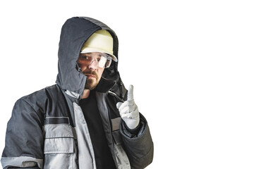 Positive friendly bearded male builder in a warm jacket, hardhat and goggles. Shows a hand gesture. Isolated background.