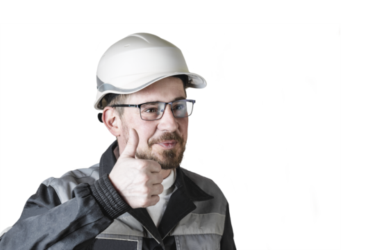 Positive friendly bearded male builder in overalls, hardhat and goggles showing thumbs up. Isolated background.