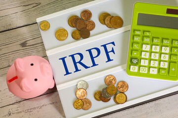 A sigla IRPF para Imposto sobre a Renda das Pessoas Físicas escrita em quadro de letras. Imposto de Renda no Brasil. - obrazy, fototapety, plakaty