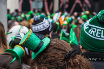 Green hat with clover in the crowd, irish flag colours, people, real Saint Patrick's day parade in...