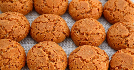 Traditional Italian almond cookies amaretti on a linen background.Famous amarettini cookie biscuits.
Delicious pastry popular in Italy.Selective focus.