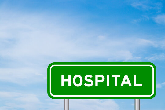 Green color transportation sign with word hospital on blue sky with white cloud background